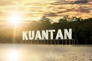 Kuantan sign on river in Kuatan, Phahang, Malaysia - River water with reflection while sunset